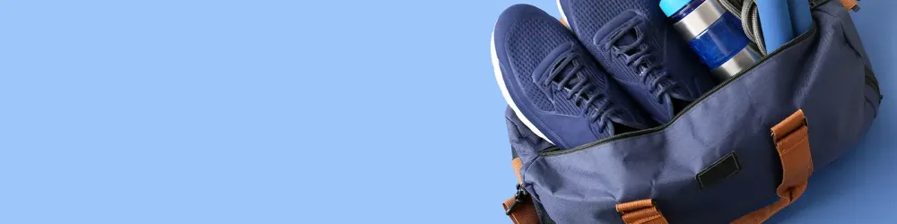 Sports bag on blue background with space for text
